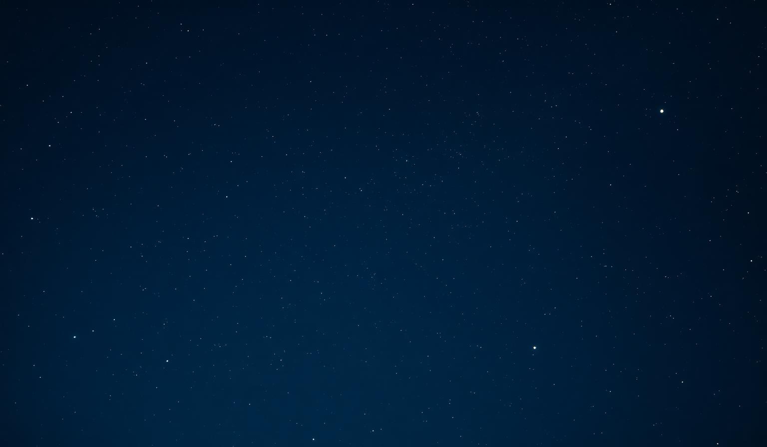 A deep night sky above a quiet horizon